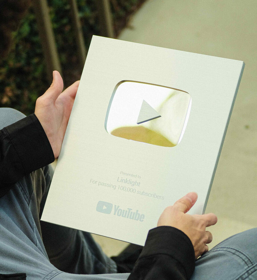 A POV Shot of someone holding a YouTube Silver Play Button Plaque
